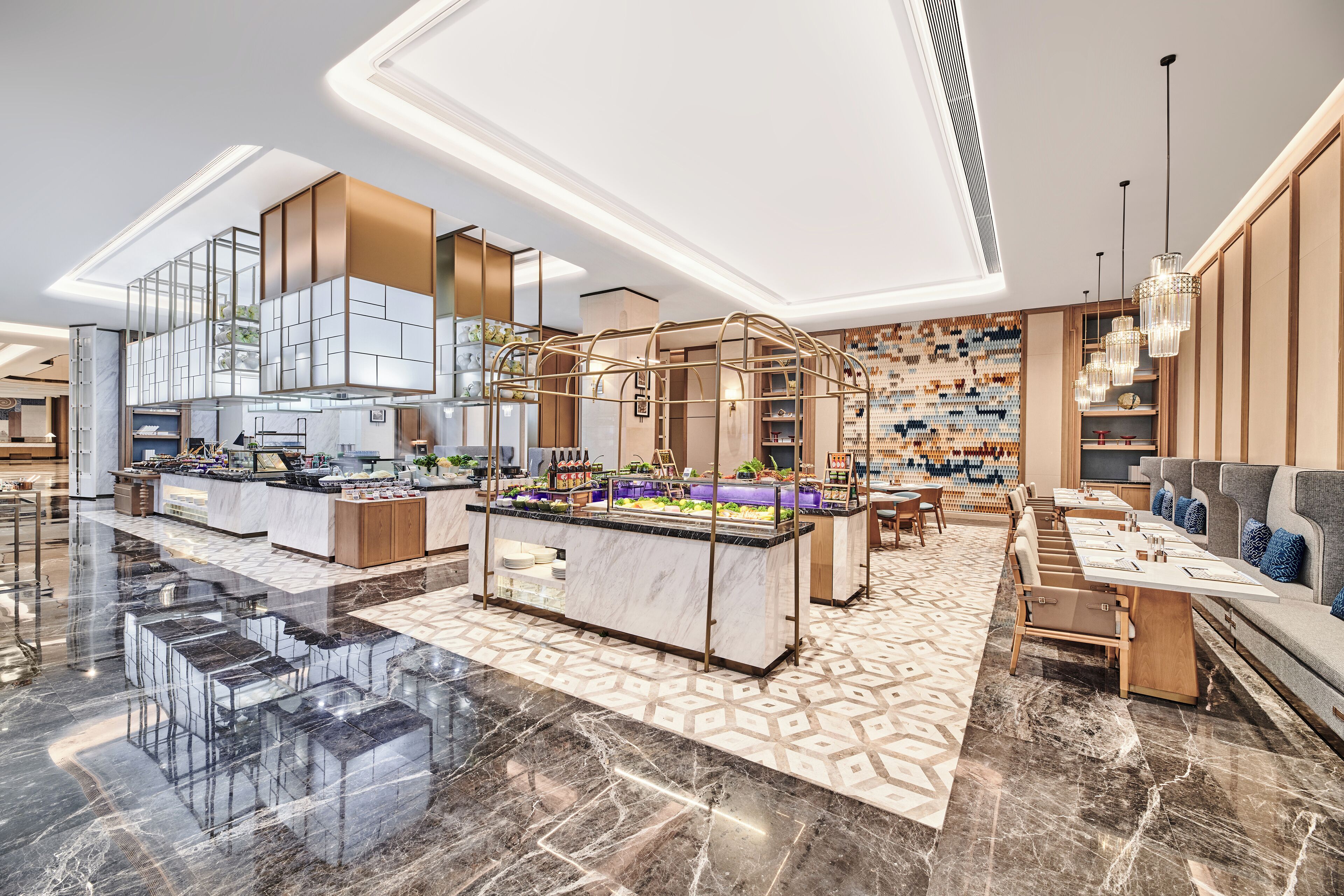 A modern hotel lobby with a central bar area, seating arrangements, and a patterned floor.