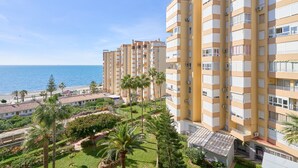 A high-rise hotel with multiple balconies, a landscaped garden, and a view of the sea. - Apartment 'Centro Internacional A117' with Sea View, Wi-Fi and Air Conditioning (Torrox)