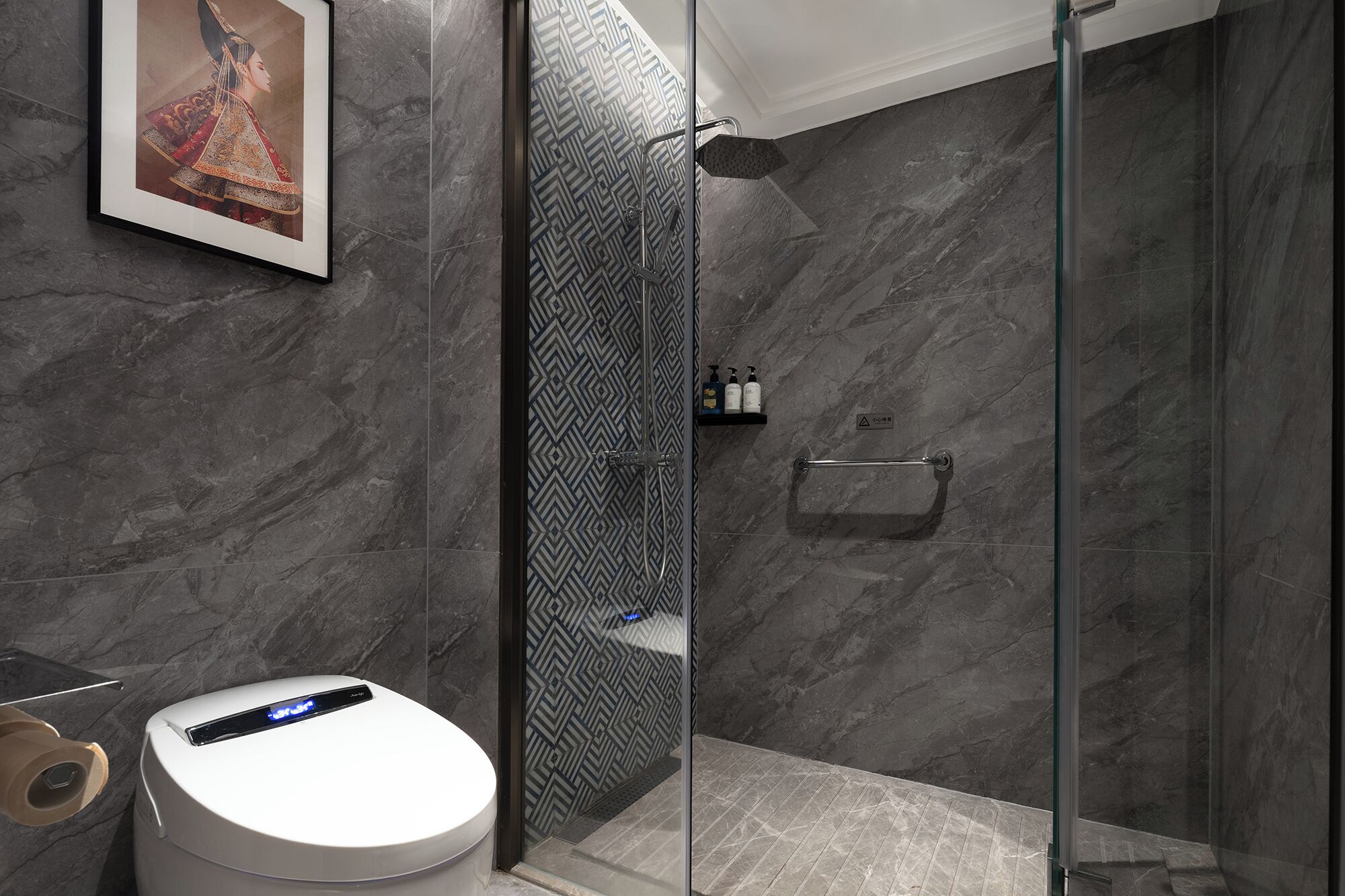 A modern bathroom with a glass shower enclosure, marble walls, and a toilet with a digital display.