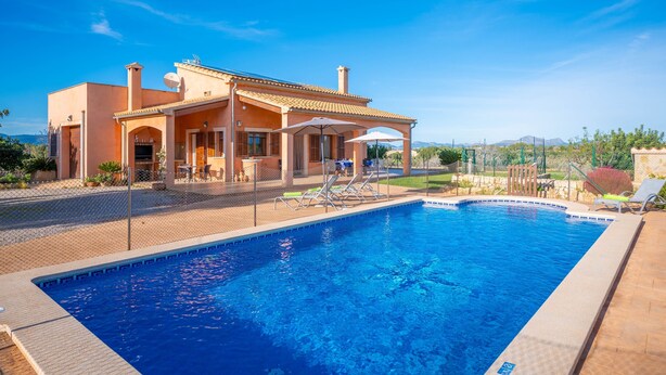 A swimming pool area with a covered patio, lounge chairs, and a view of the surrounding landscape. - Son Morro Ca Na Poveta (Santa Margalida)