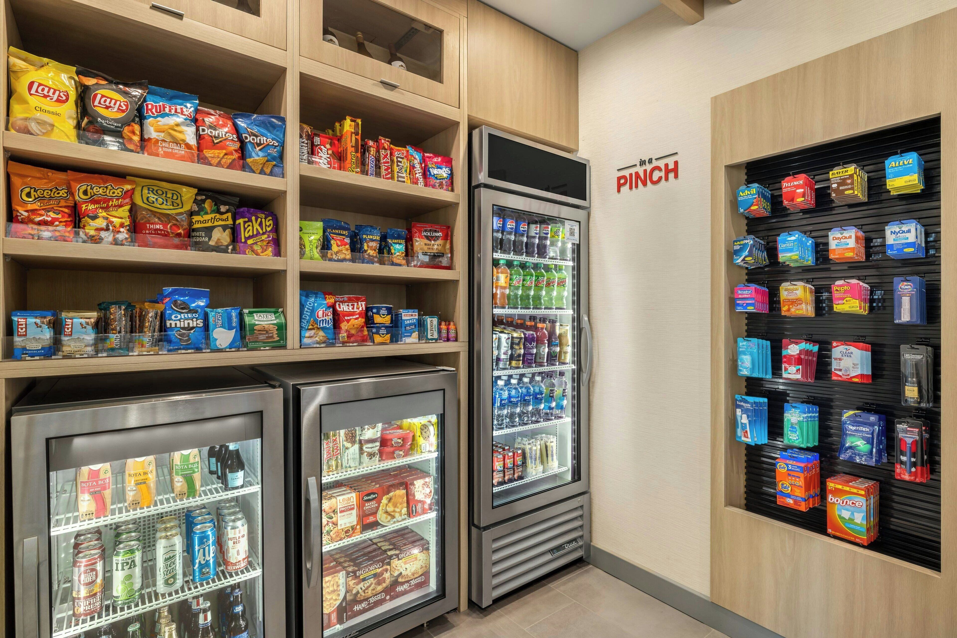 A snack and beverage vending area with various brands of chips, snacks, and drinks.