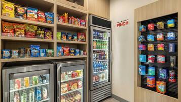 A snack and beverage vending area with various brands of chips, snacks, and drinks.