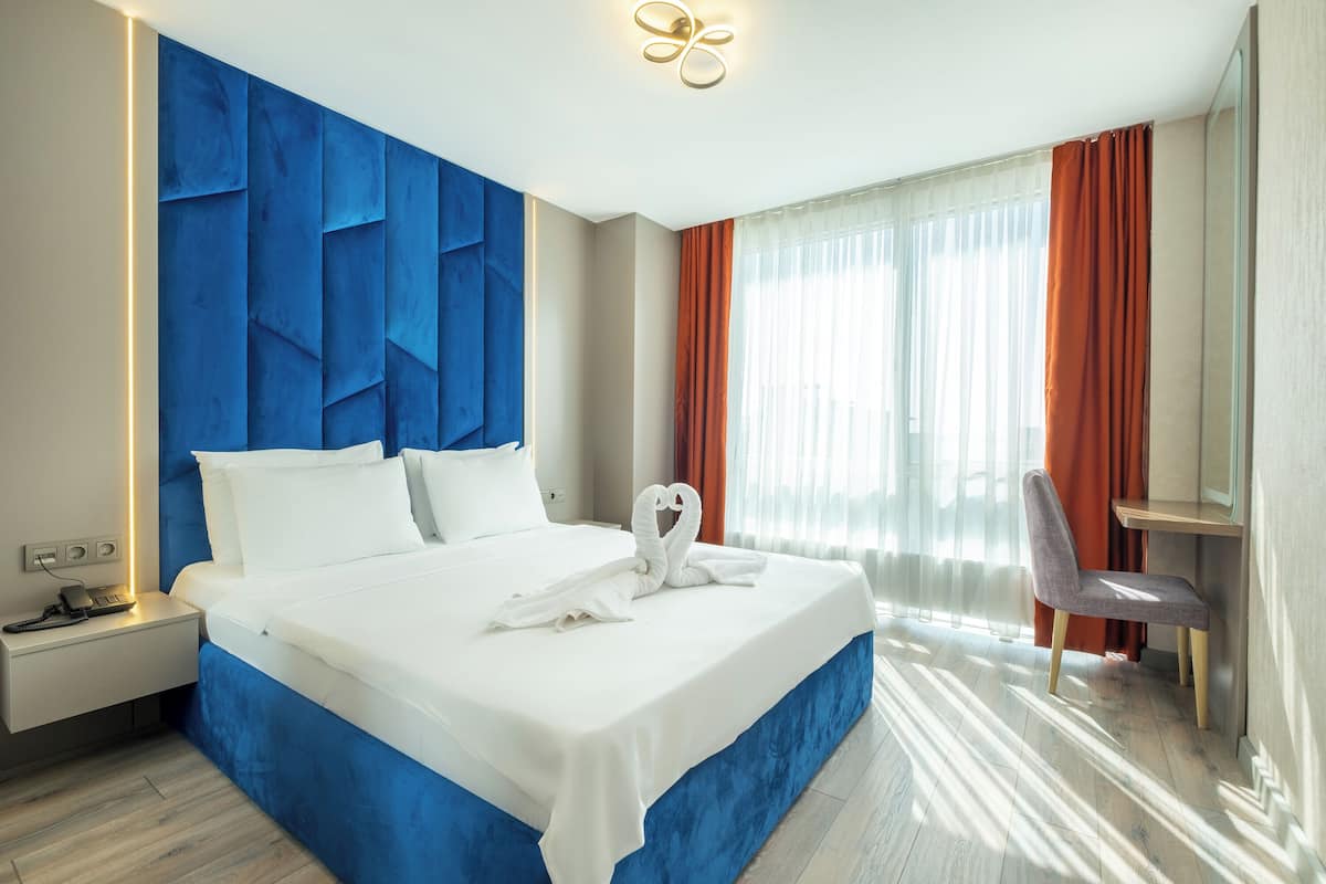 Deluxe Quadruple Room, Sea View | Desk, laptop workspace, soundproofing, iron/ironing board