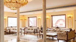 A luxurious lobby with ornate chandeliers, elegant sofas, and a grand staircase. - HOTEL THE FORT (Amroha)