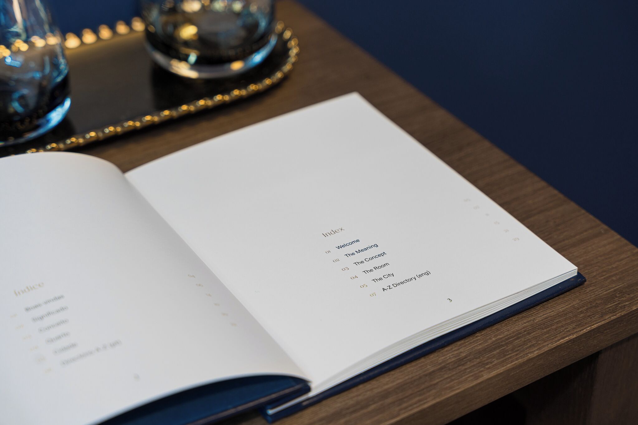 An open book on a wooden table with a list of index entries.