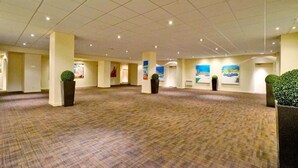 A spacious indoor area with a patterned carpet, multiple columns, and artwork on the walls. - Stunning 1 bedroom short term let in Aberdeen city center close to all amenities (Aberdeen)