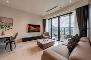 Family Apartment | Living area | 60-inch flat-screen TV with cable channels - SURI- METROPOLE Thu Thiem Apartment (Ho Chi Minh City)
