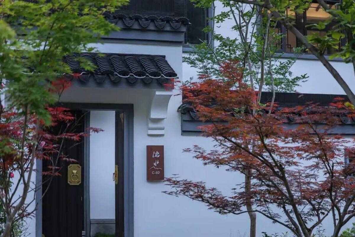 A traditional building with a tiled roof and a door with a brass handle.