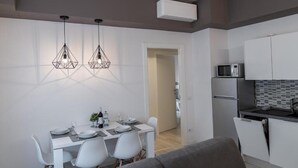A modern kitchen with white cabinets, a microwave, and a built-in oven. - DOLCE NOTTE APARTMENTS (Verona)