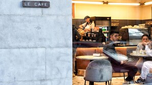 A cafe named "Paul Le Café" with outdoor seating and a modern interior design.