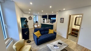 Relax in this cozy living space with a central sofa, small table, and single chair.