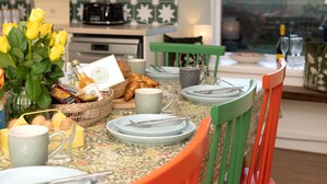 A breakfast table set with plates, cups, and a basket of croissants. - Old Duffus Farmhouse on Scottish Estate - stunning castle views (Elgin)