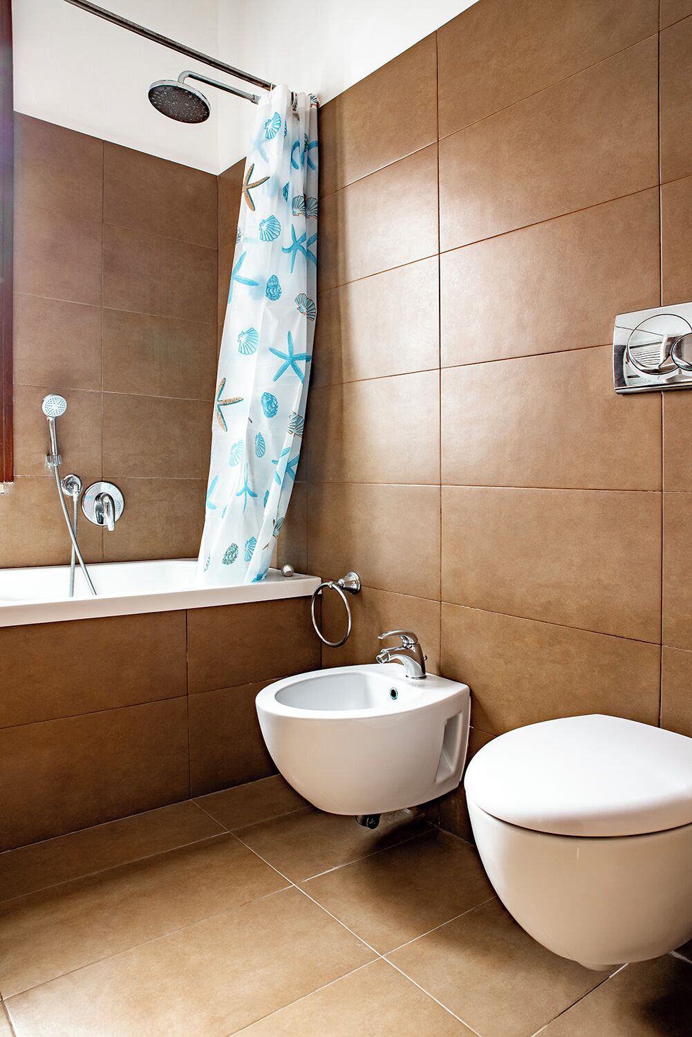 A bathroom with a shower, sink, and toilet.