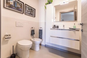 Bidet, towels, soap, toilet paper