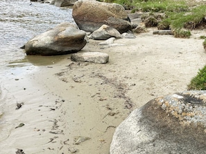 A sandy beach with large rocks and a calm water body. - 3 Person Holiday Home in Solvesborg (Sölvesborg)