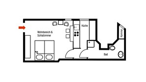 Plan d’étage d’un hôtel comprenant un salon et un coin repas, une cuisine, une salle de bain et une pièce séparée portant l’inscription « Salle de bain ».