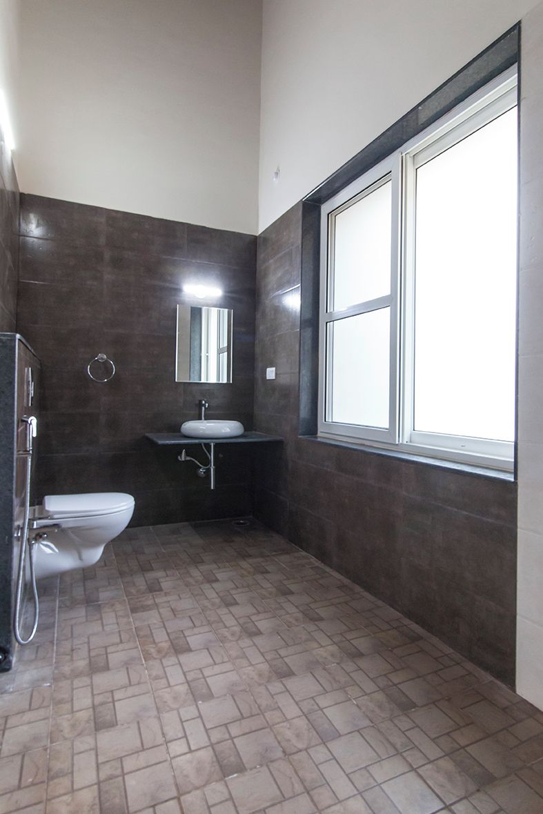 Egy fürdőszoba, amelyben WC, mosdókagyló és tükör található.