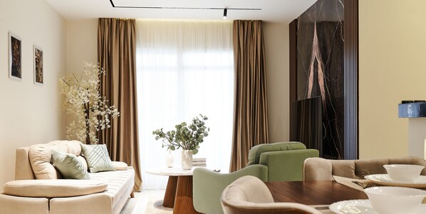 A modern living room with a sofa, chairs, a dining table, and a large window with curtains. - Sokon Residence Madinaity (New Cairo)