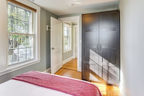A bedroom with a bed, a window, and a wardrobe. - Walk to Constitution Beach: Mid-century Boston Gem (Boston)