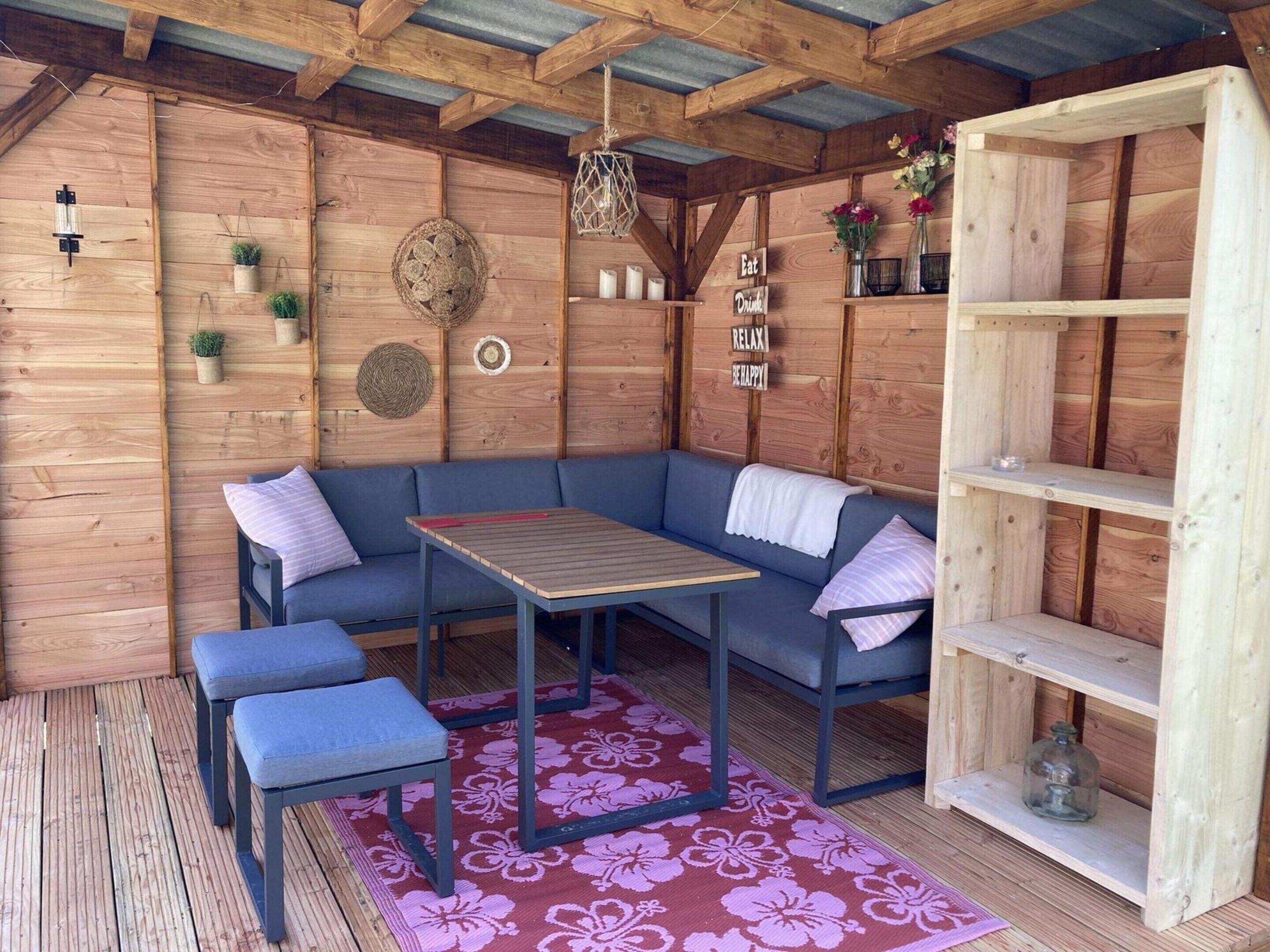 A cozy wooden room with a built-in bench, a table, and a bookshelf.