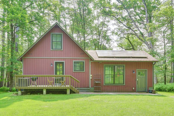 A two-story wooden cabin with a front porch, a small attached shed, and a well-maintained lawn. - Lake Front Cottage With Loft in Narrowsburg! (Narrowsburg)