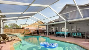 A covered swimming pool with a patio area, lounge chairs, and a table. - 3 Mi to Marina: Riverview Family Home w/ Lanai! (Riverview)