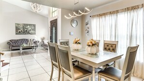 A dining area with a glass-top table, cushioned chairs, and decorative vases. - 3 Mi to Marina: Riverview Family Home w/ Lanai! (Riverview)