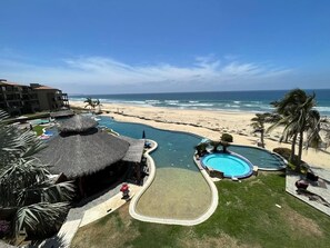 A resort with a pool, beach, and ocean view. - Sol Pacifico Cerritos Deluxe Oceanfront Condo (Los Cerritos)