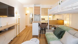 A compact, modern room with a bunk bed, a desk, and a sofa. - Stylish & fully equipped apt. only 5 min to metro. Nice area near the Bastille.  (Paris)