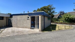 A small, modern building with a brick facade and a flat roof, likely a facility or office. - Appealing Holiday Home for Family (Sint Maartensvlotbrug)