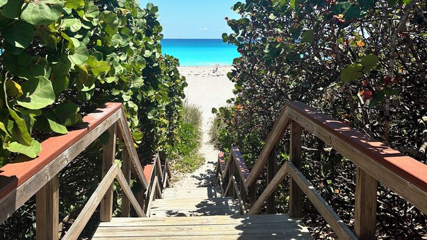 A wooden pathway leading to a beach with a clear blue sky. - SALT HAUS Top Rated 6BR/6BAContemporary Retreat, Heated Pool/Spa. Walk to Beach! (Juno Beach)