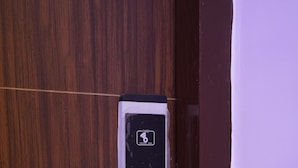 A door with a digital lock and a card reader, likely for room access or payment. - Hotel Rajmahal Palace (Prayagraj)