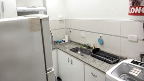 A modern kitchen with white cabinets, a stainless steel sink, and a built-in dishwasher. - Luminoso, muy Completo y Bien Ubicado (Buenos Aires)