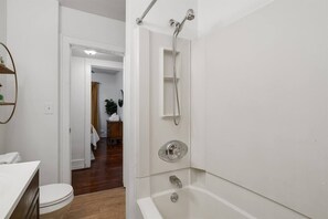 A modern bathroom with a shower, toilet, and sink. - Pet-friendly Furnished Apt Near Emu Free Parking 2 Bedroom Apts (Ypsilanti)