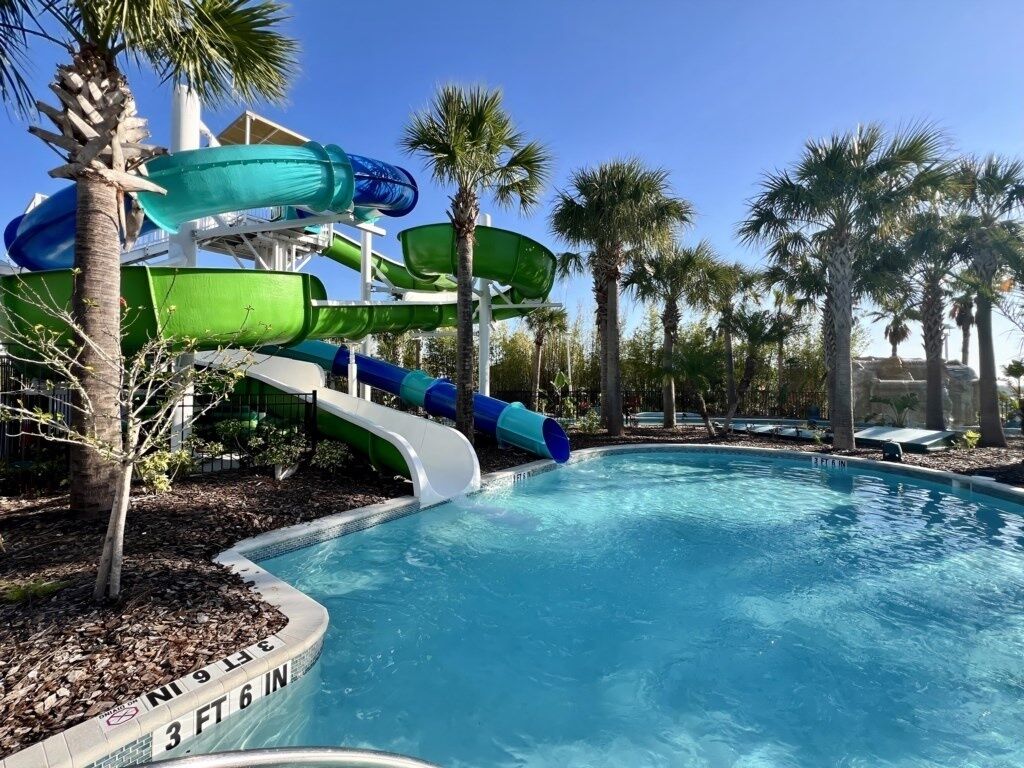 A water park with multiple slides and a pool.