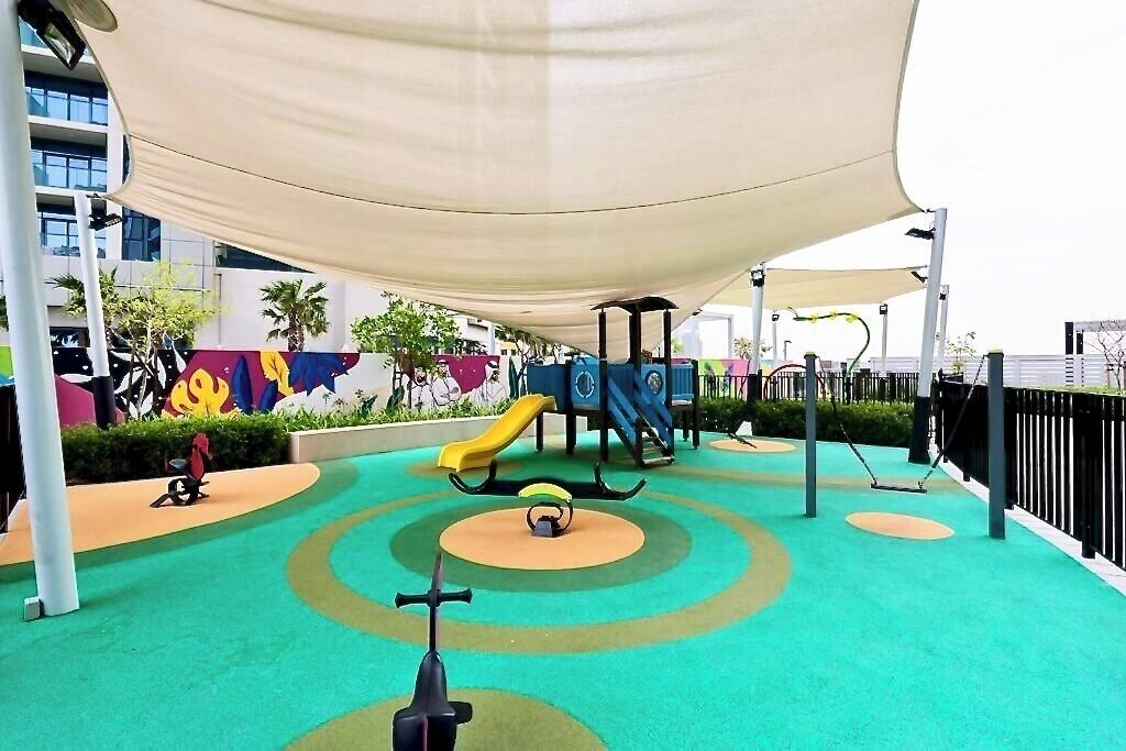 A playground with a slide, swings, and a climbing structure.