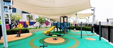 A playground with a slide, swings, and a climbing structure.
