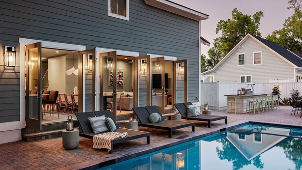 A modern outdoor pool area with lounge chairs and a bar. - 14BR Luxury Compound | Private Pool, Built-in spa (Savannah)