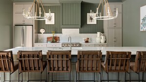 A modern kitchen with a central island, wooden chairs, and pendant lighting. - 14BR Luxury Compound | Private Pool, Built-in spa (Savannah)