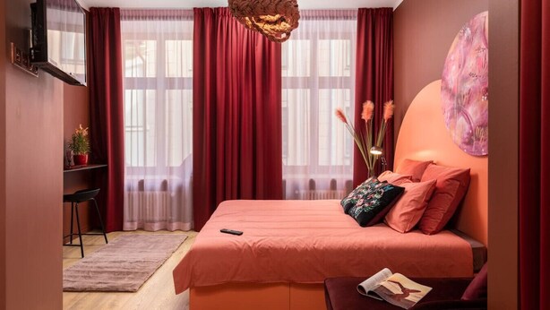 A bedroom with a bed, a desk, and a chair. - Romantic studio apartment in Old Town Riga (Rīga)