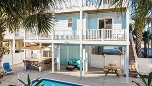 A two-story house with a pool, outdoor seating, and a balcony. - Sonrise 5-bedroom, 5.5-bathroom home w/ private pool, ~4 mins to the beach! (Ocean Isle Beach)