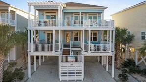A two-story beachfront house with a covered front porch, multiple balconies, and a number 149 sign. - Sonrise 5-bedroom, 5.5-bathroom home w/ private pool, ~4 mins to the beach! (Ocean Isle Beach)