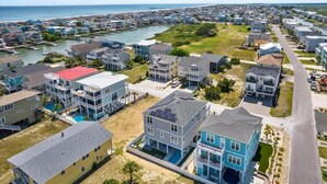 A coastal residential area with houses, a marina, and a beach.