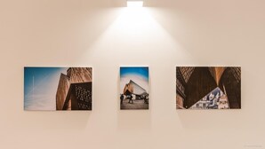 Three framed photographs of architectural structures on a wall. - Charming House in Ghent (Gent)