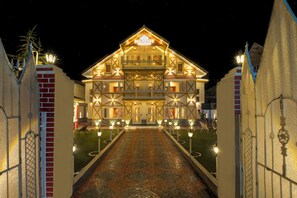 A large, illuminated building with a prominent sign reading "PAL PENZI". - PalPenzy - Bespoke Premium Stay (Srinagar)