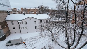 A building with multiple windows and a snow-covered roof. - Pernavas studio loft with free parking (Riga)