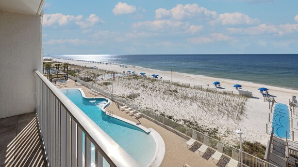 A pool area with a view of the beach and ocean. - Ocean House 1403 by Liquid Life (Gulf Shores)