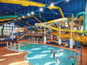 An indoor water park with a large pool, water slides, and various play structures. - Great Wolf Lodge Naples (Naples)