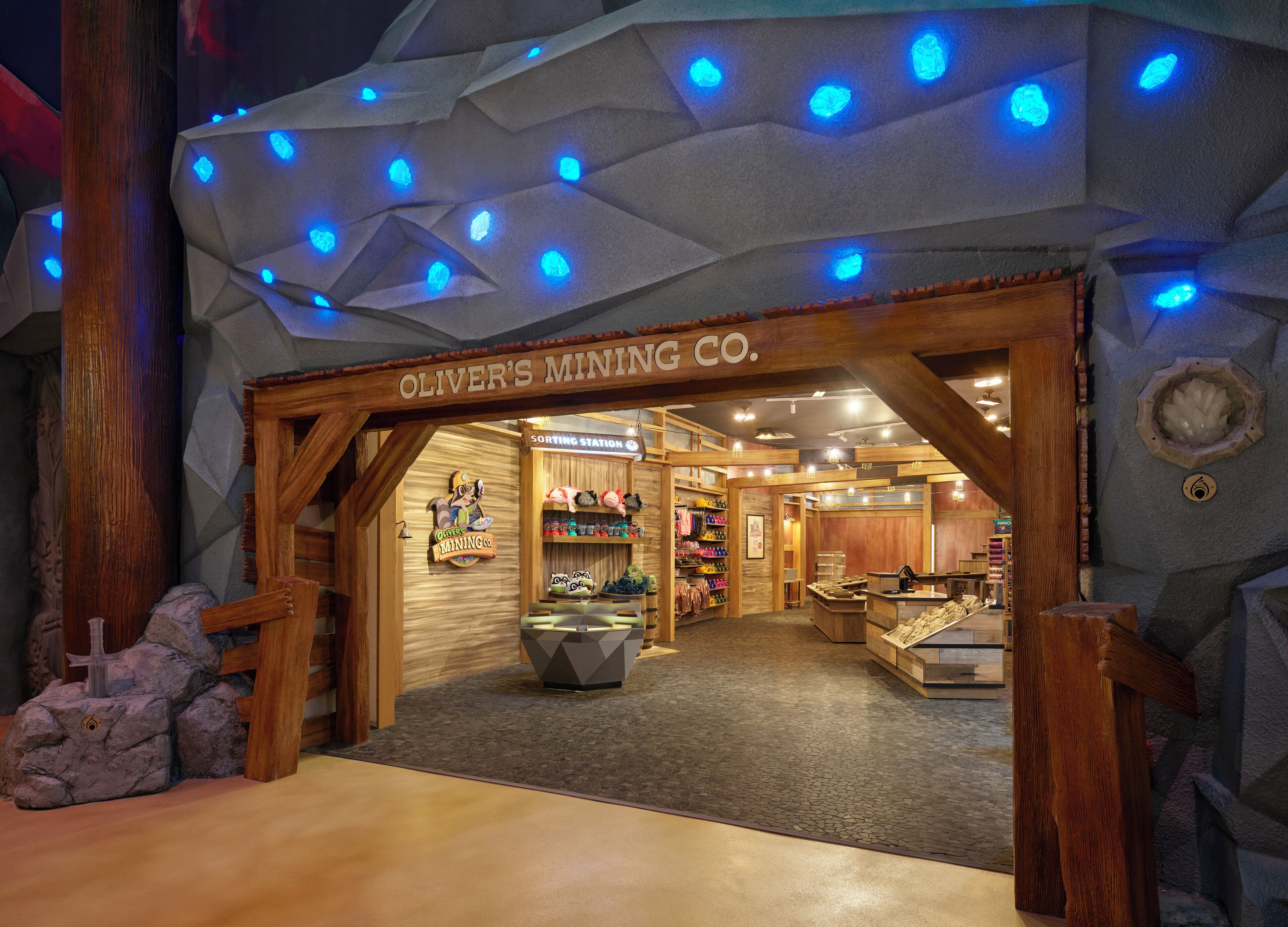 A wooden interior with a sign reading "Oliver's Mining Co." and a sorting station.