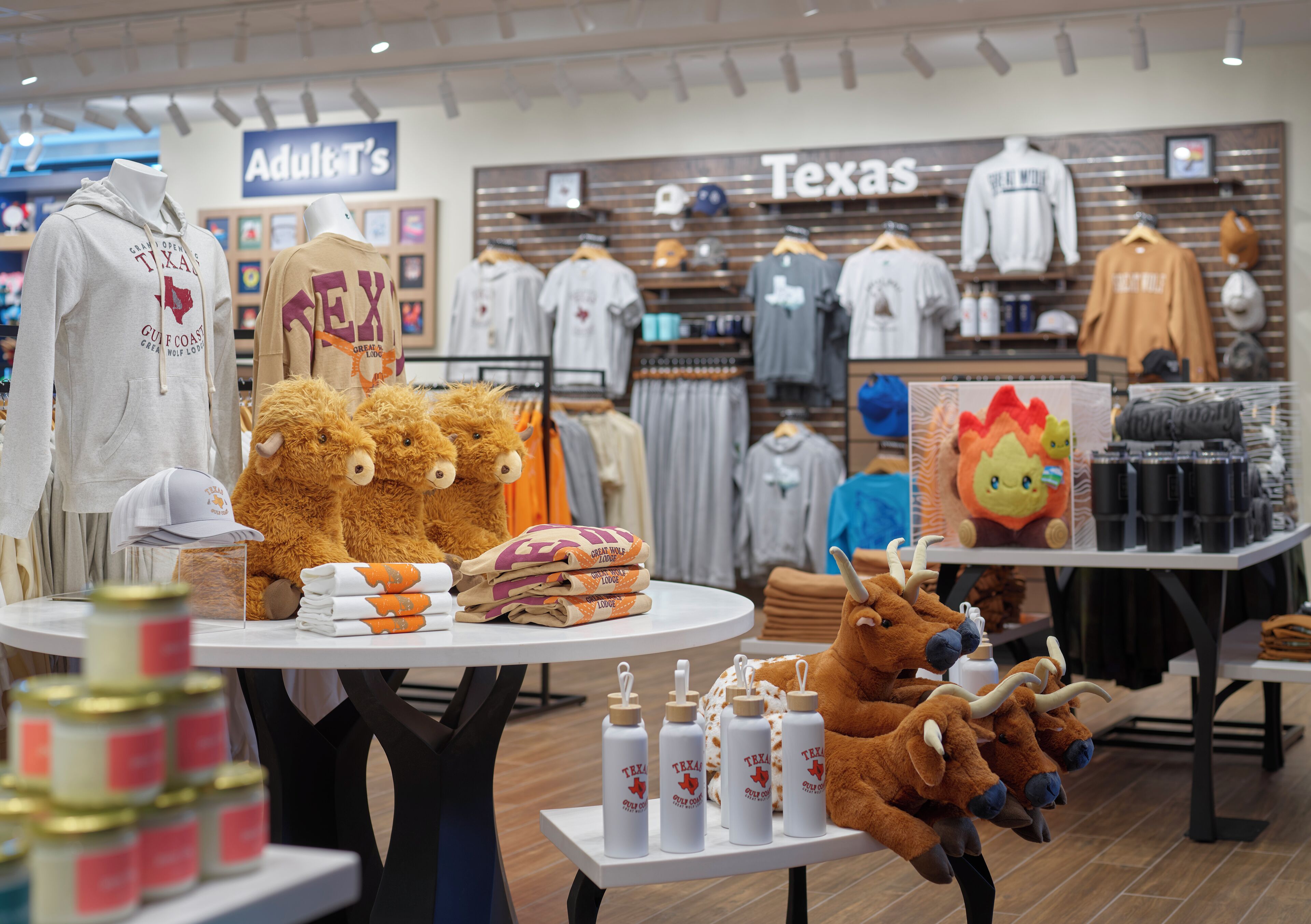 A retail store with various clothing items and stuffed toys on display.